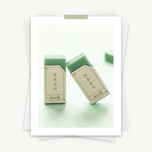 May include: Two green rectangular erasers with white labels. The labels have gold lettering that reads "抹茶 生方" and "抹茶 限定".