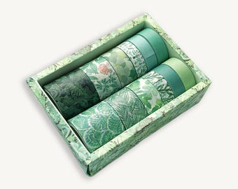 May include: A rectangular box containing ten rolls of decorative tape in various shades of green. The rolls feature diverse patterns including botanical leaves, geometric scales, and solid colors, all housed in a matching green patterned box.