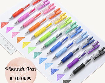 May include: Set of 18 colorful gel pens with clear barrels. The pens are arranged in a row with the ink color showing. The ink colors are: red, pink, orange, yellow, green, light blue, blue, dark blue, purple, black, and gray.