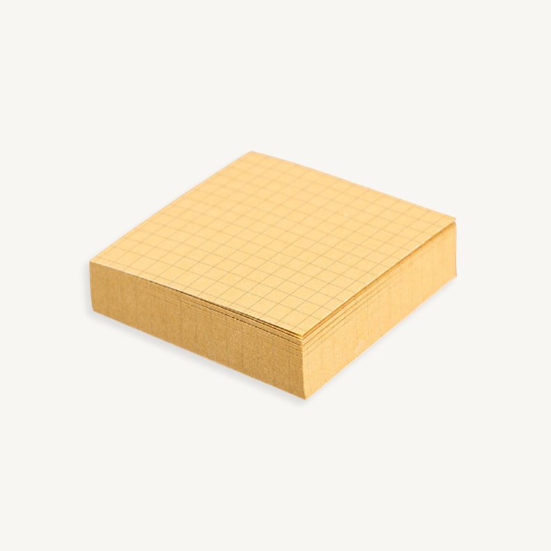 May include: A stack of yellow sticky notes with a grid pattern.