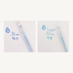 May include: Two clear plastic pens with blue ink. The pen on the left is labeled "Blue" in English and Korean. The pen on the right is labeled "Light Blue" in English and Korean.