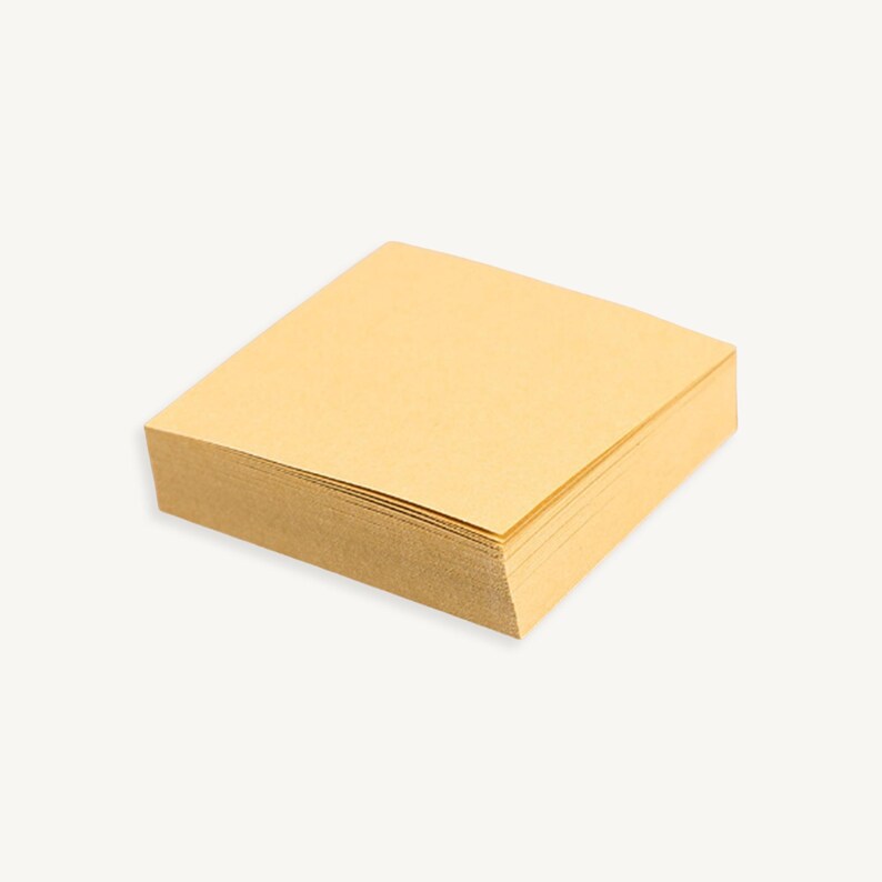 May include: A stack of square, light brown sticky notes.