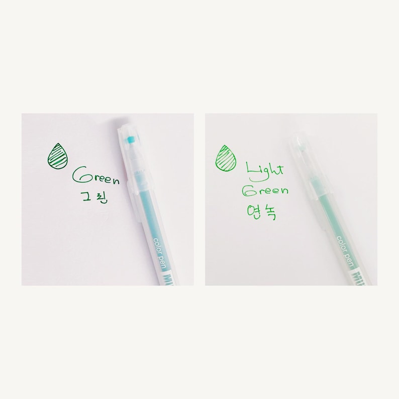 May include: Two clear plastic pens with green ink. The pen on the left has a light blue ink color and the pen on the right has a light green ink color. The pens are labeled "Green" and "Light Green" in English and Korean.
