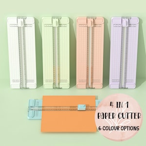 May include: Four paper cutters in white, green, peach, and lavender, with a blue paper cutter cutting orange paper. The image includes a pink circle with the text "4 IN 1 PAPER CUTTER 6 COLOUR OPTIONS."