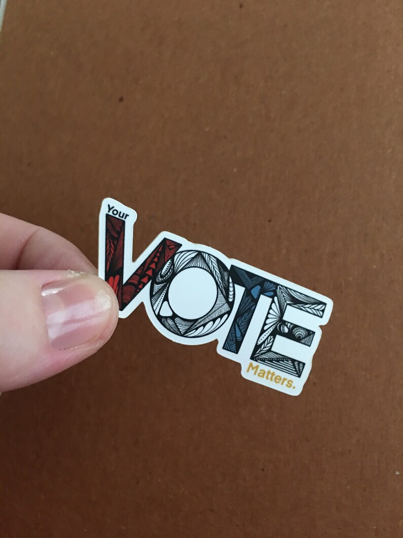 May include: A sticker with the word "VOTE" in black and white with red, blue, and white accents. The word "Your" is above the word "VOTE" and the word "Matters." is below the word "VOTE".