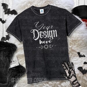 May include: Black t-shirt with a distressed, vintage look. The shirt has a white graphic that says "Your Design Here" with a crescent moon, sun, and star design.