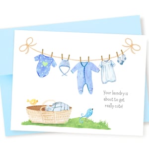May include: A baby shower card with a blue and white watercolor illustration of baby clothes hanging on a clothesline. The text on the card reads "Your laundry is about to get really cute!"