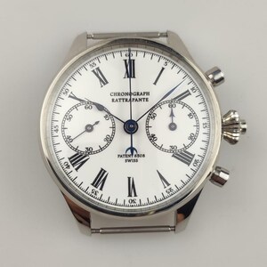 May include: A silver wristwatch with a white face, black Roman numerals, and sub-dials. The watch face displays "CHRONOGRAPH RATTRAPANTE" and "PATENT 8508 SWISS". The watch has a stainless steel strap.