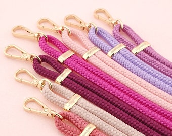 May include: A set of seven colorful braided phone straps with gold clasps and the word "Keepwee" printed on each strap.