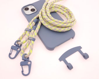 May include: A blue phone case with a bright yellow and gray lanyard. The lanyard has two clips on the ends. The case has a camera lens cutout and a small blue plastic piece.