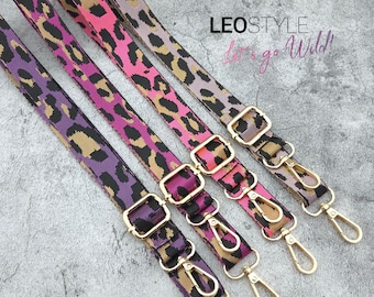 May include: Four colorful leopard print bag straps in purple, pink, and tan. Each strap has gold-colored metal hardware, including adjustable buckles and swivel clasps. The text "LEOSTYLE" and "Let's go Wild!" are visible.
