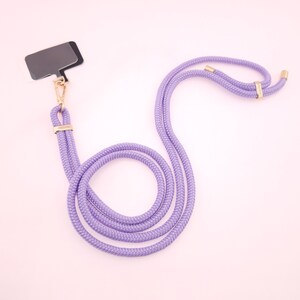 May include: A purple lanyard with a gold clasp and a black name tag. The lanyard is made of a thick, braided rope.