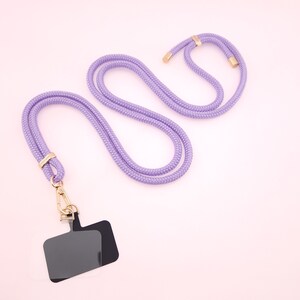May include: A purple lanyard with a gold clasp and a black rectangular badge holder.