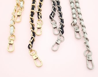 May include: Three chain straps with gold, silver, and black hardware. The chains are made of white, black, and silver metal. The chains are all the same length and have a lobster clasp at the end.