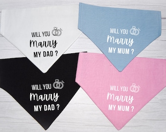 May include: Four dog bandanas with the text "Will you marry my dad?" and "Will you marry my mum?" printed on them. The bandanas are in white, black, light blue, and pink.