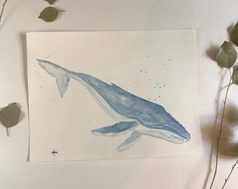 May include: Watercolor painting of a blue whale swimming in a light blue ocean. The whale is painted in a realistic style with a detailed depiction of its body and fins. The background is a light blue color with white dots representing water droplets.
