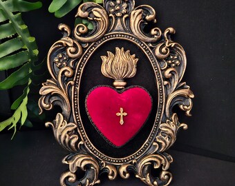 Framed red velvet sacred heart with gold flame and cross, gothic art. Mounted on black velvet in a burnished gold hand cast ornate frame.