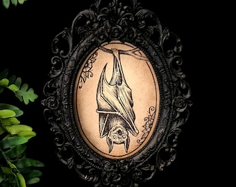 Hand painted bat, mounted in a black oval frame. Gothic art, vampire