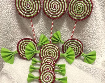 May include: A set of six Christmas ornaments featuring red, white, and green candy canes and lollipops. The ornaments are made of felt and have a glittery finish.
