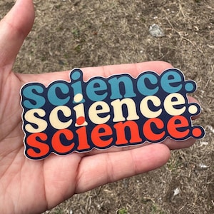 May include: A sticker with the word "science" repeated three times in a retro style font. The word is in blue, cream, and red on a white background.