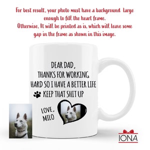May include: White ceramic coffee mug with a black paw print and the text "Dear Dad, Thanks for working hard so I have a better life. Keep that shit up. Love, Milo". A white dog with blue eyes is pictured in a black heart shape.