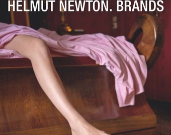 May include: A poster advertising an exhibit of Helmut Newton's work at the Helmut Newton Foundation in Berlin. The poster features a woman's leg and foot, a pink blanket, and a jeweled snake. The text on the poster reads "HELMUT NEWTON. BRANDS", "SHOWCASING SPECIAL HERITAGE PIECES BY SWAROVSKI", "HELMUT NEWTON FOUNDATION | MUSEUM FÜR FOTOGRAFIE | 3.12.2022 - 14.5.2023", "JEBENSSTRASSE 2, 10623 BERLIN | DI, MI, FR, SA, SO 11-19, DO 11-20 UHR".