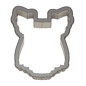Peut inclure: Un emporte-pi&egrave;ce en m&eacute;tal en forme de silhouette stylis&eacute;e d'une personne portant une robe. L'emporte-pi&egrave;ce a un bord festonn&eacute; et une forme arrondie et lisse.