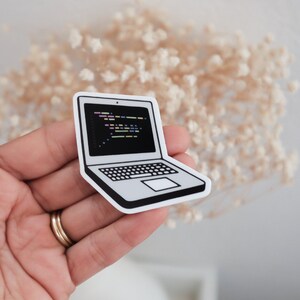 Peut inclure: Un autocollant d'ordinateur portable blanc avec un contour noir. L'&eacute;cran de l'ordinateur portable affiche du code dans diff&eacute;rentes couleurs.