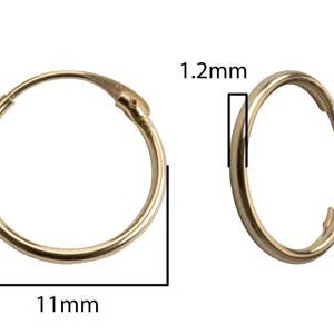 May include: A pair of gold hoop earrings, 11 mm in diameter and 1.2 mm thick.