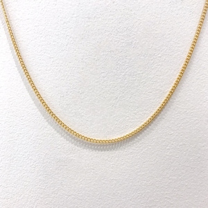 May include: A gold chain necklace with a delicate, fine link design.