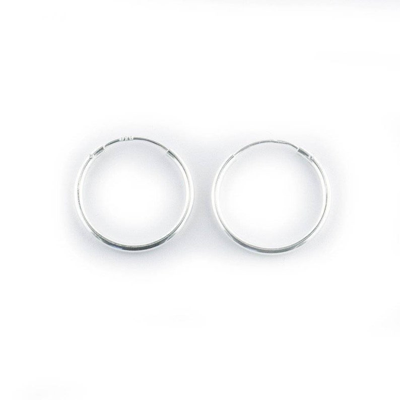 May include: A pair of silver hoop earrings. The earrings are simple and classic, and they would make a great gift for any occasion.