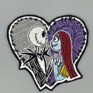 May include: Embroidered patch featuring Jack Skellington and Sally from The Nightmare Before Christmas. The patch is shaped like a heart and shows the characters looking at each other. The patch is black, white, gray, red, purple, and blue.