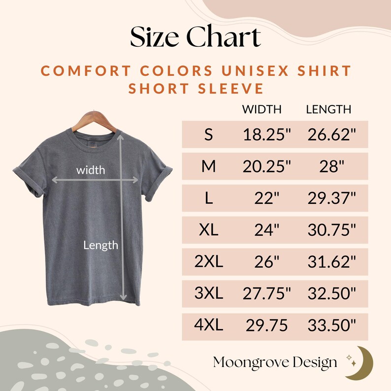 May include: A size chart for a Comfort Colors unisex short sleeve shirt. The chart lists sizes S through 4XL with width and length measurements in inches. The shirt is gray and hangs on a wooden hanger.