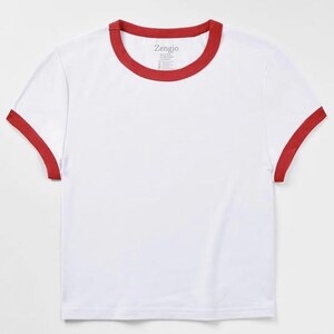May include: A white t-shirt with a red trim around the collar and sleeves. The shirt has a classic, casual style. The brand name "Zengjo" is printed on the upper right side of the shirt.