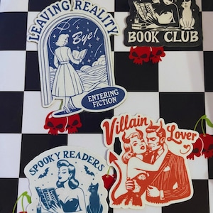 May include: Four vintage-style stickers featuring illustrations of women reading books. The stickers have a black and white checkered background. The stickers are titled "Leaving Reality", "Spooky Readers Book Club", "Spooky Readers Book Club", and "Villain Lover".