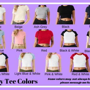 May include: A chart displaying various colour options for baby tees. The colours include white, beige, ash grey, black, navy, light blue, pink, red, black and white, black and ash, navy and white, light blue and white, pink and white, and red and white. The text "Baby Tee Colors" is at the bottom of the chart. The text "Some colours may not always be available, please message me for more info" is at the bottom of the chart.