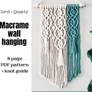May include: A macrame wall hanging in cream and teal. The cream section has a diamond pattern, and the teal side has a woven design. It hangs from a wooden dowel. Text on the left reads "Cord + Quartz" and "Macrame wall hanging".