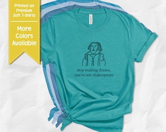 May include: Teal t-shirt with a black line drawing of a person and the text "stop making drama, you're not shakespeare." The shirt is part of a collection with more colors available. The text "Printed on Premium Soft T-Shirts" is also visible.