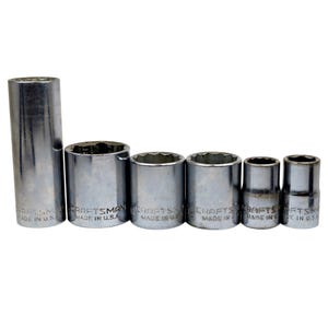 May include: A set of Craftsman brand chrome sockets of varying sizes. The sockets are cylindrical with a hexagonal opening and are arranged from largest to smallest. The text "MADE IN U.S.A." is visible on each socket.