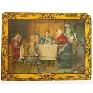 May include: A vintage print depicting a family gathered around a table. The scene shows several people in a dining room, with a woman in a red shawl and a young boy in a sailor suit. The print is framed in a decorative gold border.
