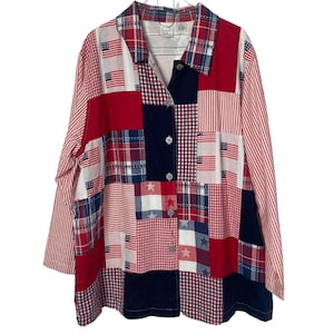 May include: A patchwork button-down shirt in red, white, and blue. The shirt features various patterns, including American flags, stars, stripes, and gingham. It has long sleeves and a collared neckline. The shirt is a patriotic themed garment.