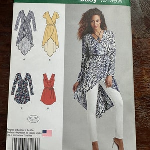 May include: Simplicity sewing pattern number 1064, size US 6-14, Euro 32-40, French 34-42. The pattern includes instructions for making a high-low wrap top with long sleeves. The pattern shows four different versions of the top, including a floral print, a solid red top, a yellow top, and a leopard print top.
