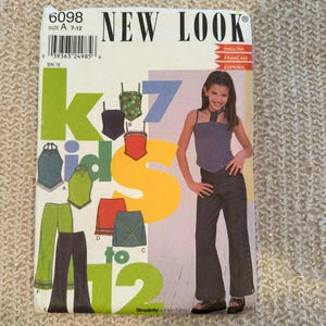 May include: A sewing pattern for kids sizes 7-12. The pattern includes instructions for making a top, skirt, and pants. The pattern is from New Look and is labeled with the number 6098.