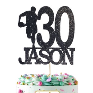 May include: Black glitter cake topper with a running figure, the number 30, and the name "JASON". The topper is on a cake with green frosting and colorful sprinkles. A white square sticker with gold text reads "Ooh Let's Party".