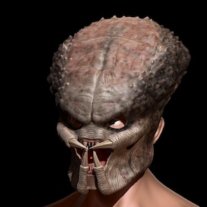 May include: A detailed 3D rendering of a Predator mask. The mask has a textured, grey-brown surface with prominent ridges and a menacing expression. The Predator's mandibles are visible, along with sharp teeth and red eyes, set against a black background.