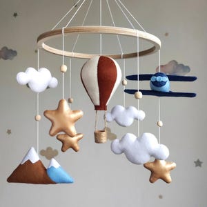Travel nursery mobile. Airplane, hot air balloon, mountain. Adventure crib mobile for baby boy. Gender neutral cot decor. Musical mobile.
