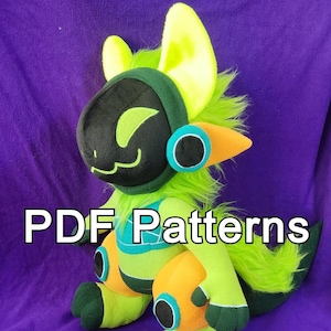 May include: A green and black plush toy with a yellow mohawk and large, round ears. The toy has a friendly expression and is sitting on a purple surface. The text "PDF Patterns" is visible in the image.