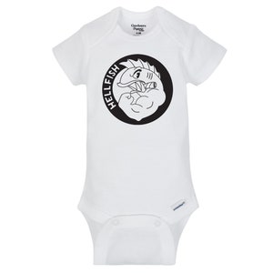 May include: White baby onesie with a black and white graphic of a muscular fish inside a black circle. The word "HELLFISH" is printed around the circle. The onesie has short sleeves and snap closures.