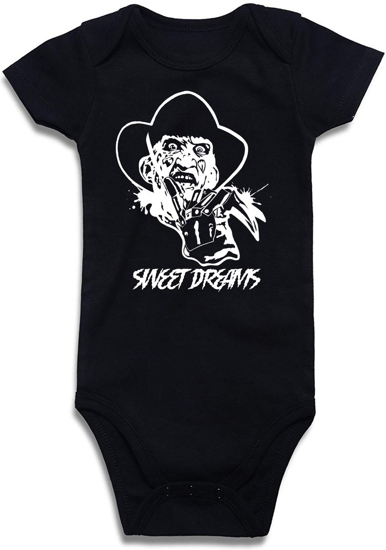 May include: Black baby bodysuit with a white graphic of a horror movie character wearing a hat and glove with blades. The text "SWEET DREAMS" is printed below the graphic.