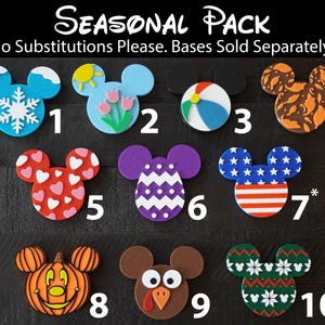 May include: A set of ten Mickey Mouse-shaped ornaments with different seasonal designs. The ornaments are numbered 1 through 10. The designs include a snowflake, a sun, a beach ball, fall leaves, hearts, a chevron pattern, an American flag, a pumpkin, a turkey, and a snowflake pattern.